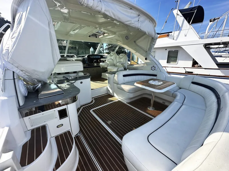 Slide: The Image of Luxurious 2006 Sea Ray 48 Sundancer yacht interior with elegant seating and wood flooring. - 6