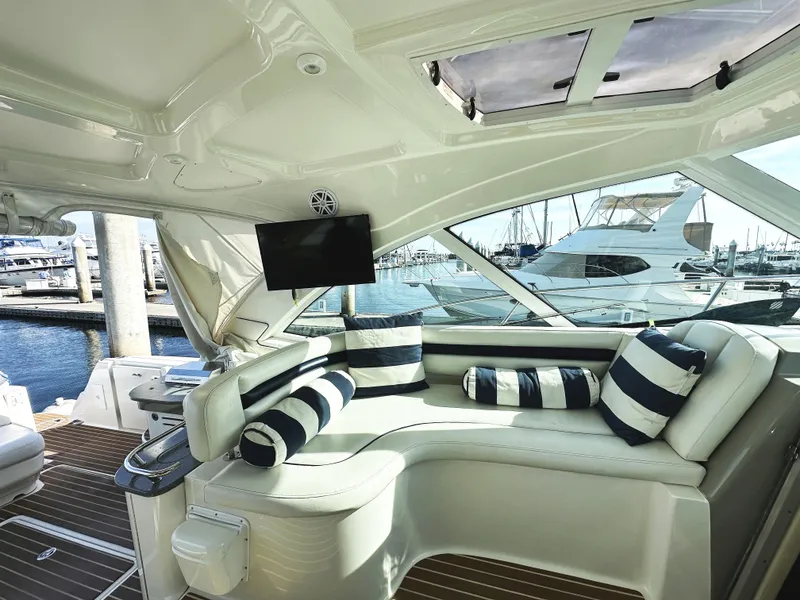 Slide: The Image of Luxurious interior of 2006 Sea Ray 48 Sundancer yacht with striped cushions and marina view. - 8