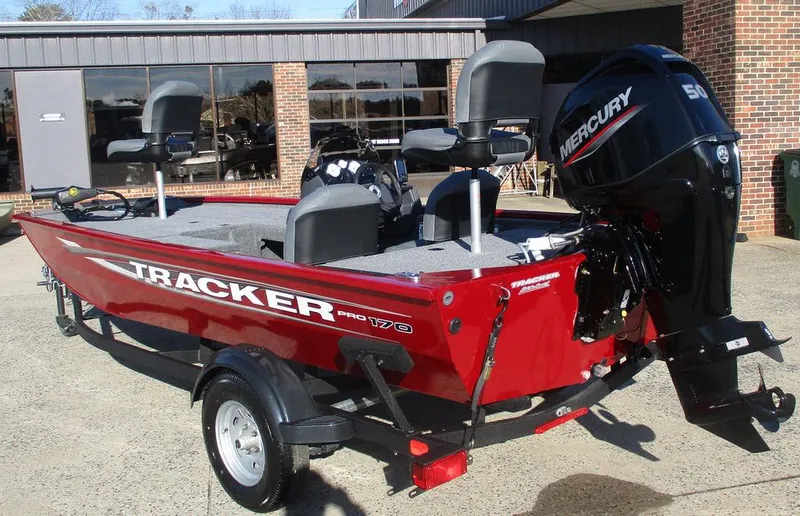 Slide: The Image of 2025 Tracker Pro 170 boat with Mercury engine, parked outdoors. - 3