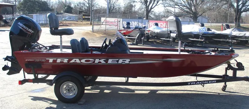 Slide: The Image of 2025 Tracker Pro 170 boat in red, parked on a trailer outdoors. - 4