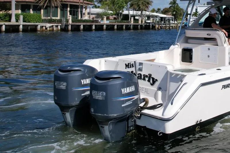 Slide: The Image of 2008 Pursuit 315 Offshore boat with twin Yamaha 250 engines on a sunny waterway. - 11
