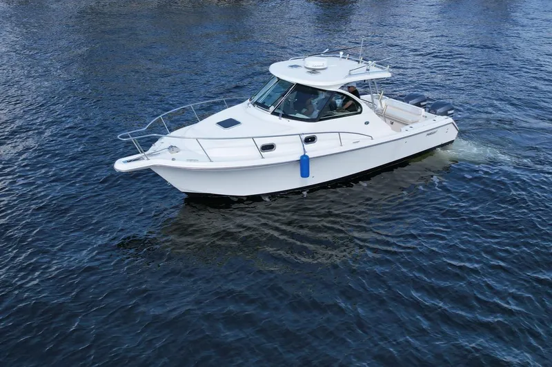 Slide: The Image of 2008 Pursuit 315 Offshore boat cruising on open water. - 14