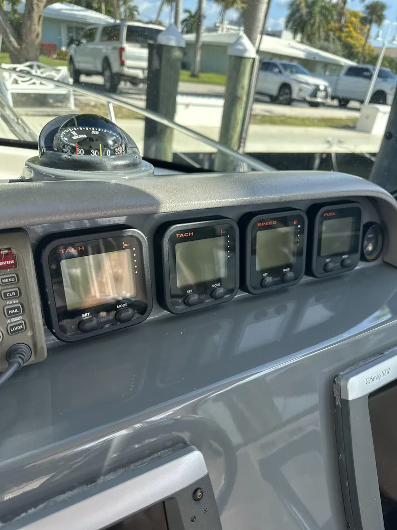 Slide: The Image of Dashboard of a 2008 Pursuit 315 Offshore boat with multiple electronic displays. - 19