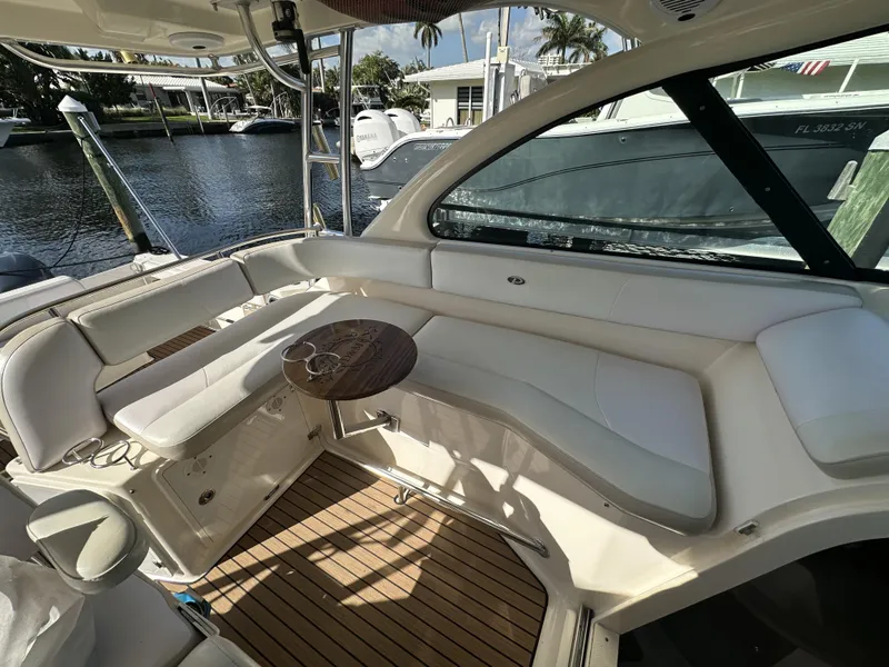 Slide: The Image of 2008 Pursuit 315 Offshore boat interior with white seating and wooden flooring. - 28