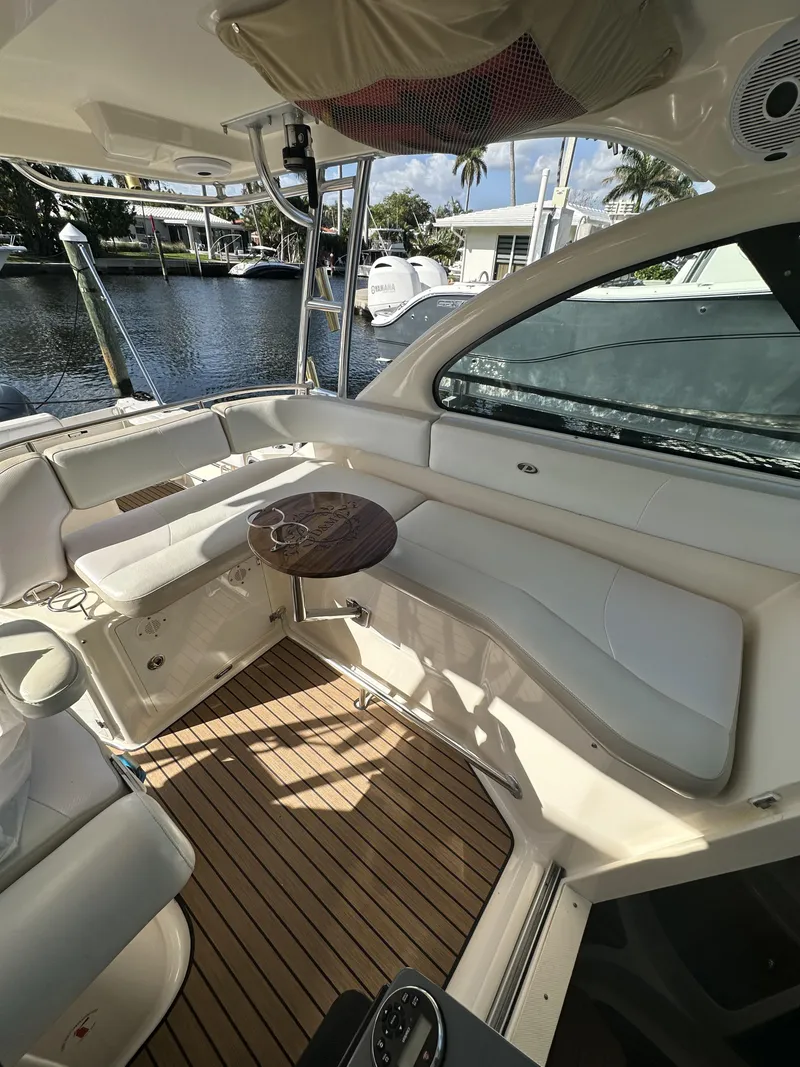 Slide: The Image of 2008 Pursuit 315 Offshore boat interior with seating and wooden flooring. - 29
