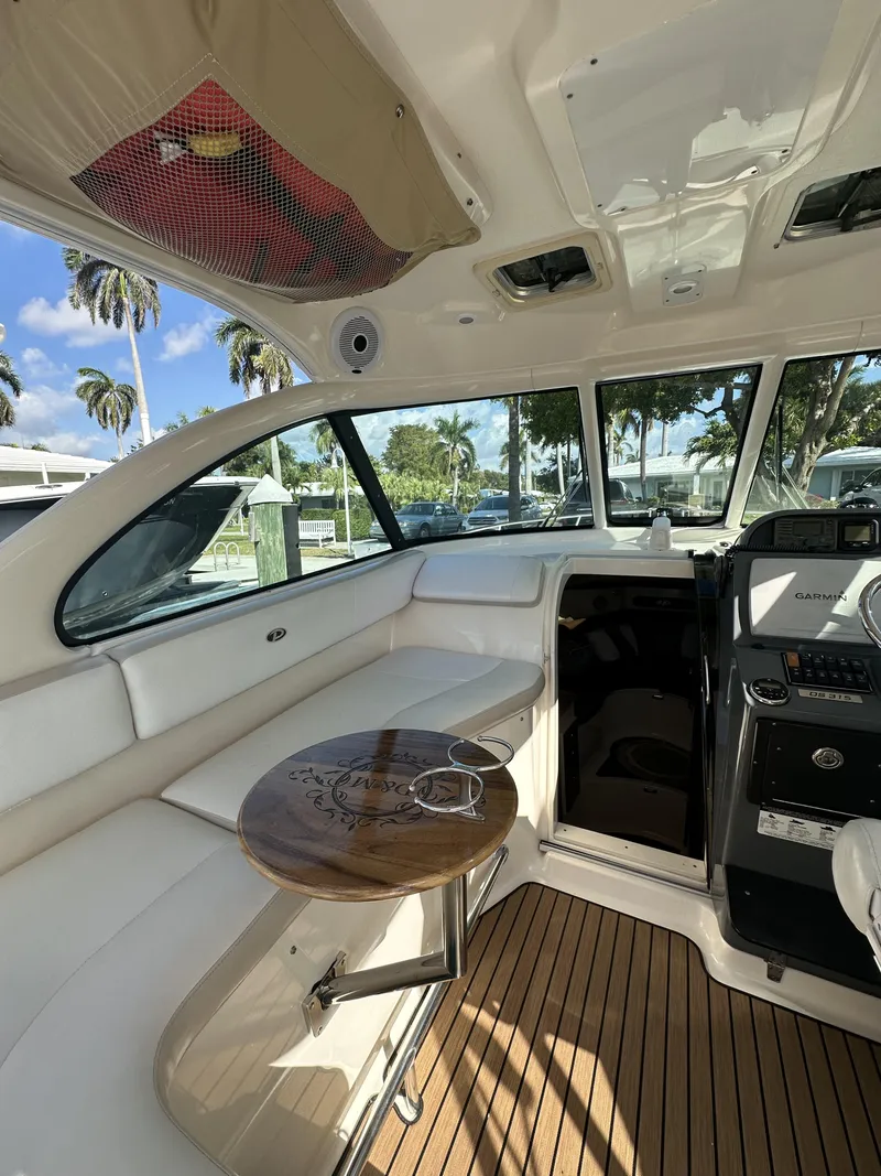 Slide: The Image of Interior of 2008 Pursuit 315 Offshore boat with seating and wooden table. - 30