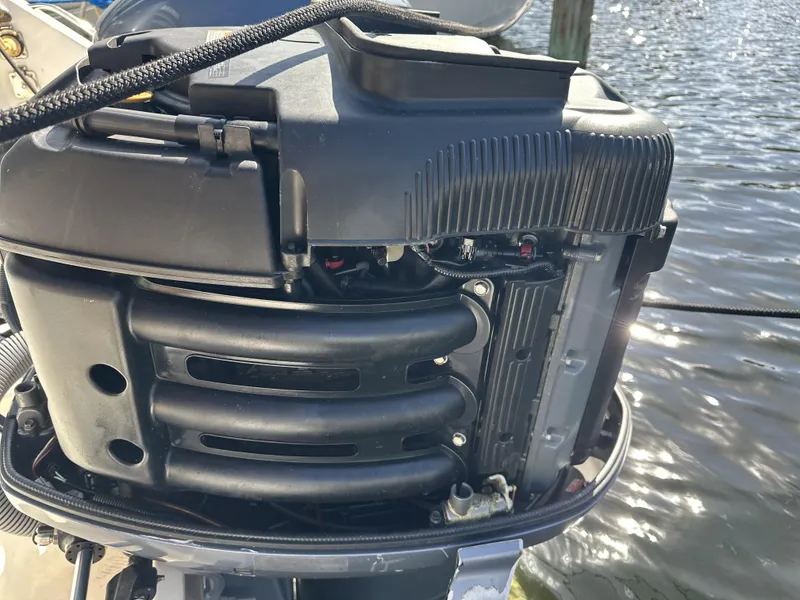 Slide: The Image of Close-up of a 2008 Pursuit 315 Offshore boat engine by the water. - 43
