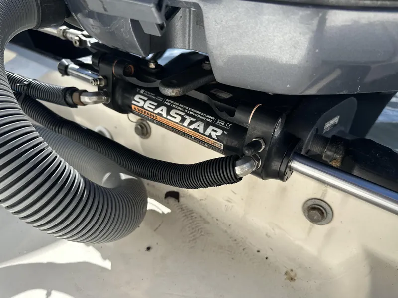 Slide: The Image of Hydraulic steering system on a 2008 Pursuit 315 Offshore boat, featuring SeaStar components. - 47