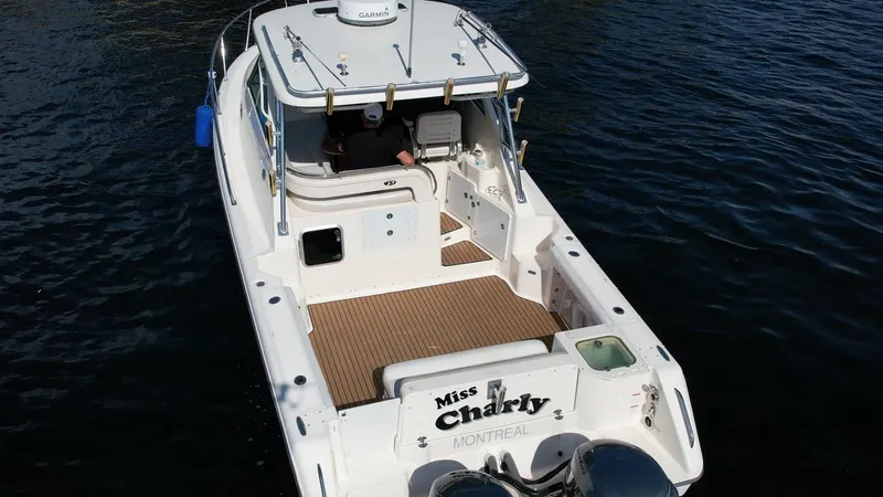 Slide: The Image of 2008 Pursuit 315 Offshore boat on water, rear view, named "Miss Charly," Montreal. - 9