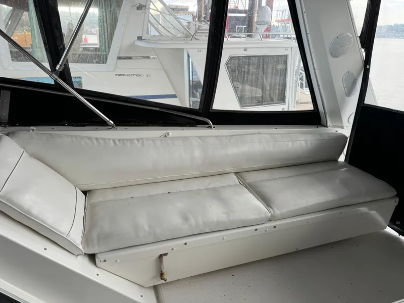 Slide: The Image of Interior seating of a 1995 Bayliner 4788 yacht with white cushions. - 11