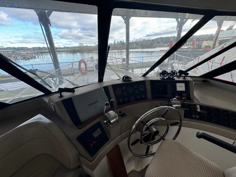 Slide: The Image of Interior helm of 1995 Bayliner 4788 yacht with steering wheel and navigation equipment. - 13