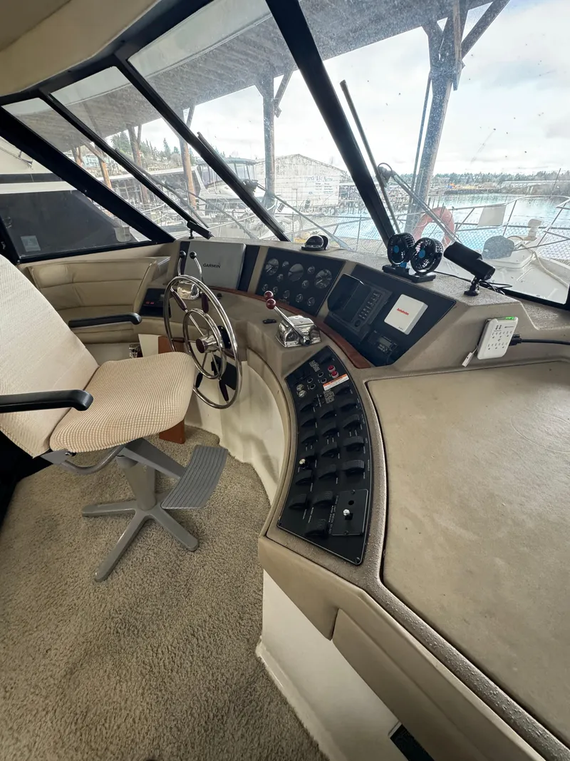 Slide: The Image of Interior helm of a 1995 Bayliner 4788 yacht with steering wheel and control panel. - 14