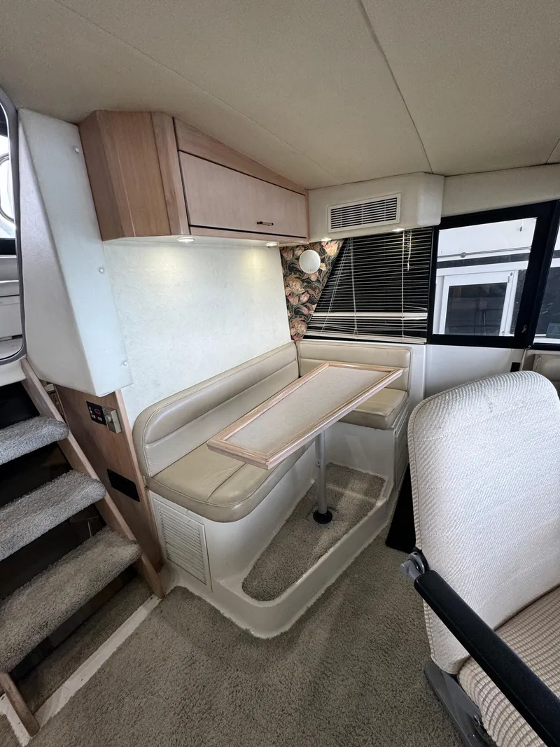 Slide: The Image of Interior of 1995 Bayliner 4788 yacht with dining area and seating. - 15