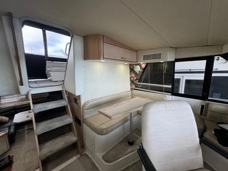 Slide: The Image of Interior of 1995 Bayliner 4788 yacht with seating area and stairs. - 16