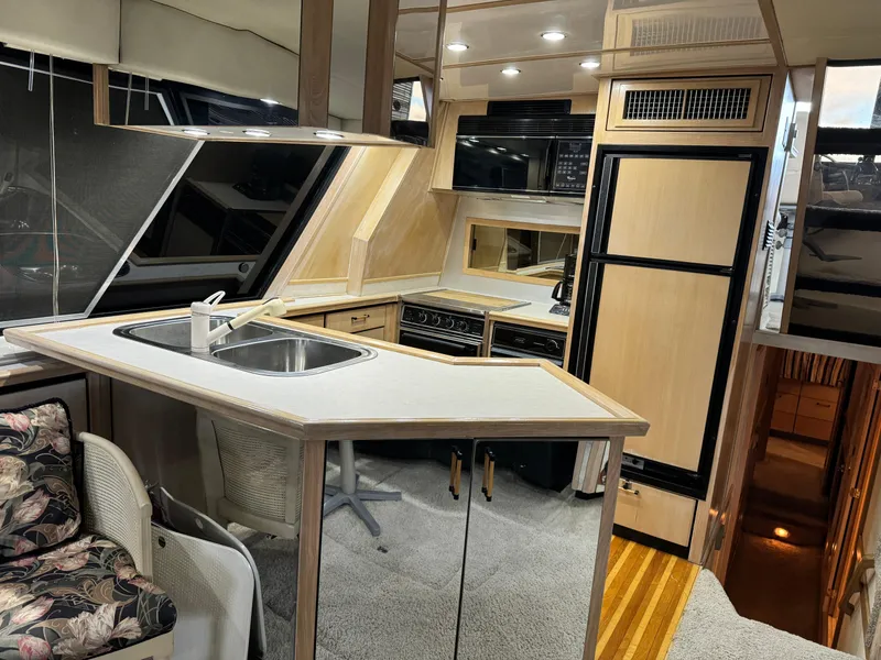 Slide: The Image of Interior of a 1995 Bayliner 4788 yacht featuring a modern kitchen area. - 18