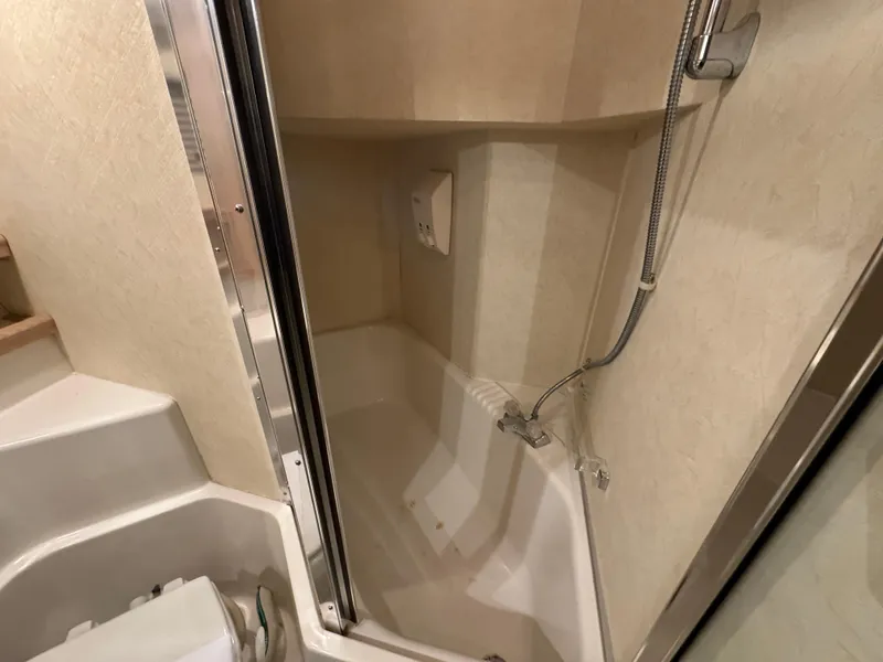Slide: The Image of Bathroom shower area in a 1995 Bayliner 4788 yacht, featuring a compact design. - 36