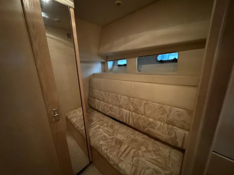 Slide: The Image of Interior cabin of 1995 Bayliner 4788 yacht with cushioned seating and small windows. - 37