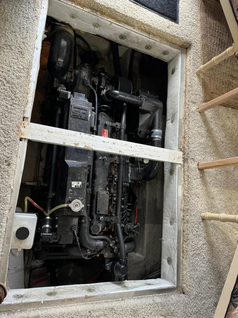 Slide: The Image of Engine compartment of a 1995 Bayliner 4788 yacht, showcasing mechanical components. - 42