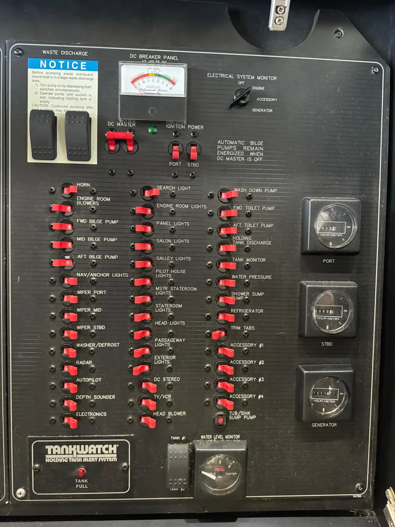 Slide: The Image of Electrical panel of a 1995 Bayliner 4788 yacht with various switches and gauges. - 43