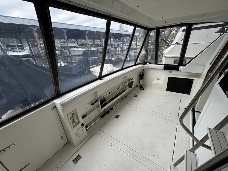 Slide: The Image of Interior view of 1995 Bayliner 4788 yacht with marina background. - 5