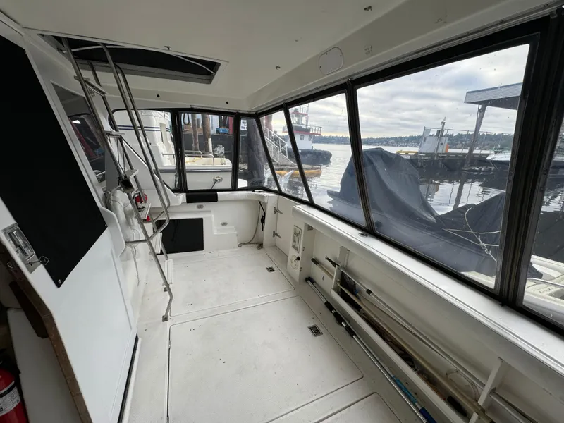 Slide: The Image of 1995 Bayliner 4788 yacht interior with large windows and dockside view. - 6