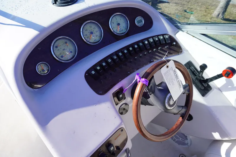 Slide: The Image of 2006 Chaparral 280SSi boat dashboard with gauges and steering wheel. - 10