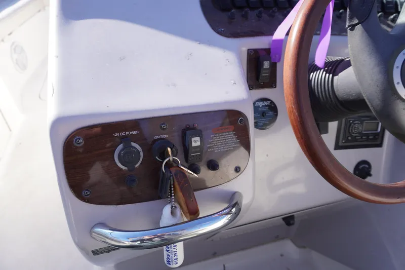 Slide: The Image of Control panel of a 2006 Chaparral 280SSi boat with ignition keys and steering wheel. - 12