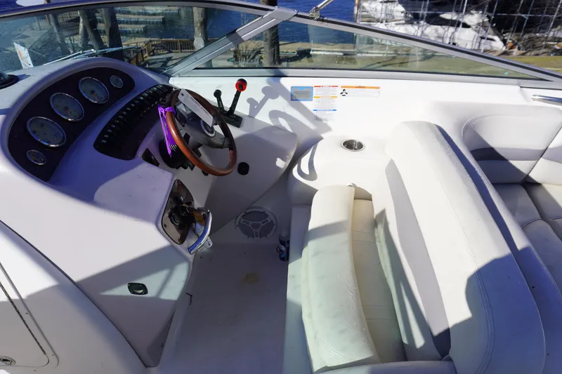 Slide: The Image of 2006 Chaparral 280SSi boat interior with steering wheel and seating area. - 16