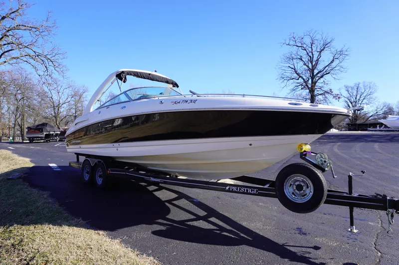 Slide: The Image of 2006 Chaparral 280SSi boat on trailer, parked outdoors on a sunny day. - 2