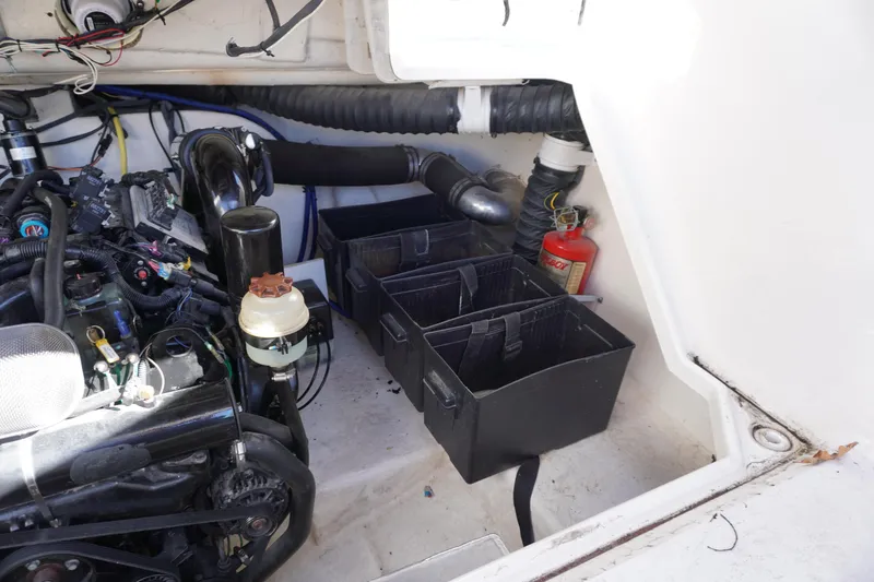 Slide: The Image of Engine compartment of a 2006 Chaparral 280SSi boat with storage and fire extinguisher. - 5