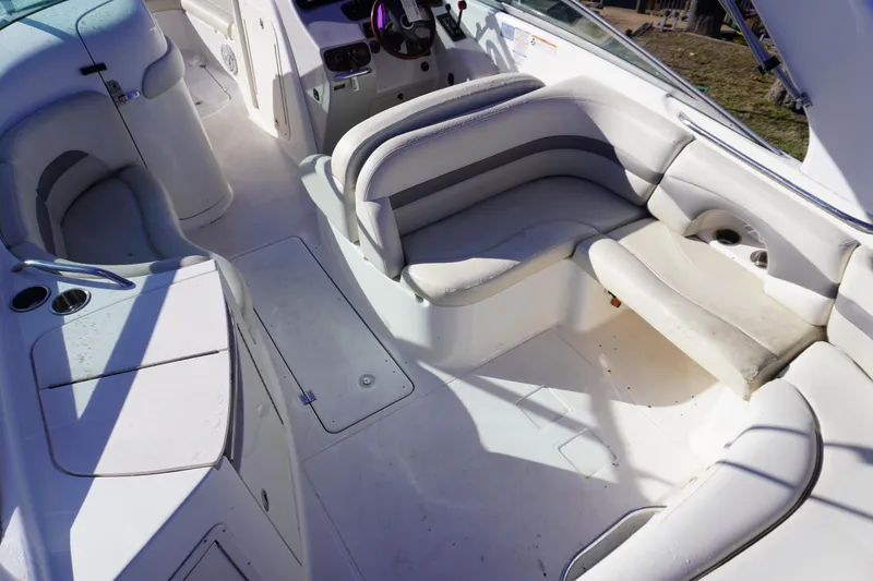 Slide: The Image of 2006 Chaparral 280SSi boat interior with white seating and helm area. - 8