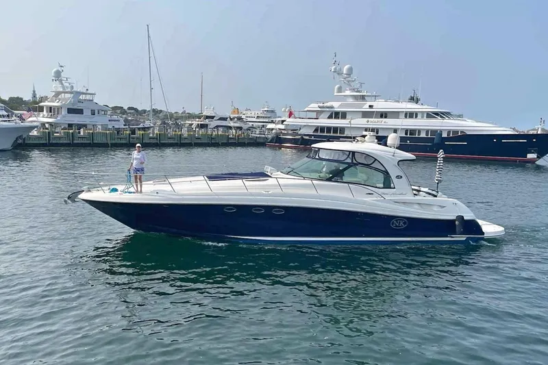 The Image of 2004 Sea Ray 500 Sundancer yacht docked in a marina with other boats. - 0