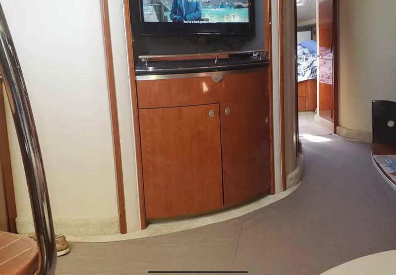 Slide: The Image of Interior of 2004 Sea Ray 500 Sundancer yacht with wood cabinetry and mounted TV. - 12
