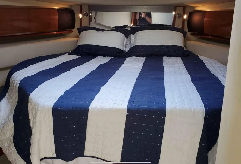 Slide: The Image of Luxurious cabin interior of 2004 Sea Ray 500 Sundancer with striped bedding. - 13