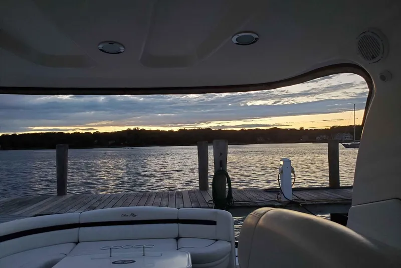 Slide: The Image of 2004 Sea Ray 500 Sundancer interior view with sunset over water and dock. - 4