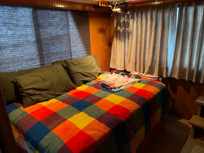 Slide: The Image of Cozy bedroom in 1996 Gibson 41 Sunsport with colorful plaid bedding and wooden interior. - 10