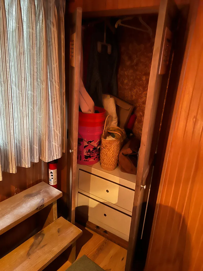 Slide: The Image of Interior closet of 1996 Gibson 41 Sunsport boat with wooden paneling and storage items. - 13