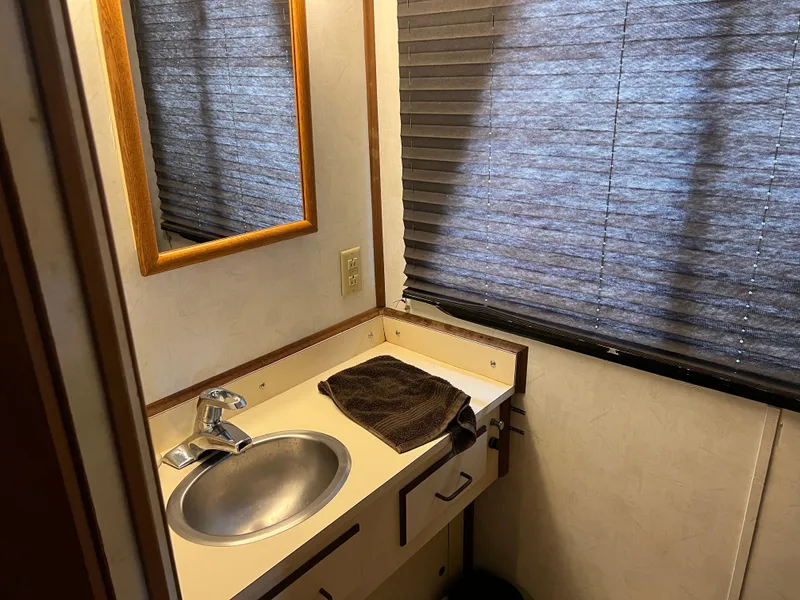 Slide: The Image of Bathroom interior of 1996 Gibson 41 Sunsport with sink, mirror, and window blinds. - 15