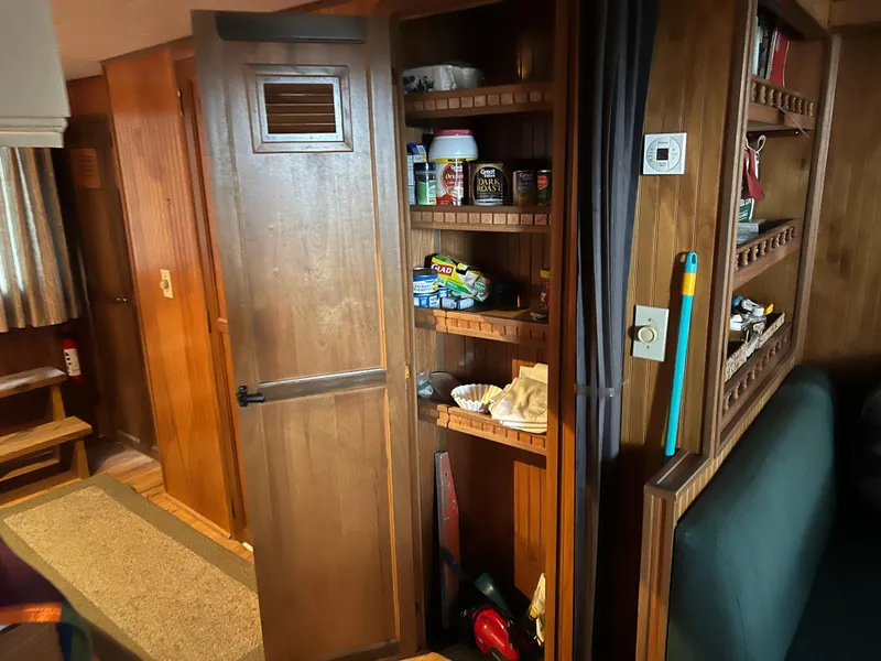 Slide: The Image of Interior of 1996 Gibson 41 Sunsport showing wooden cabinetry and storage shelves. - 17