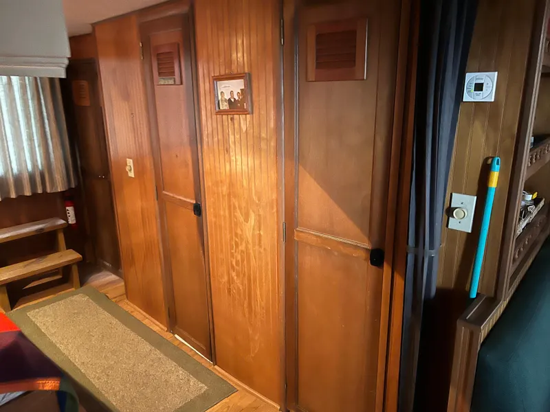 Slide: The Image of Interior of 1996 Gibson 41 Sunsport boat with wooden paneling and carpeted floor. - 18