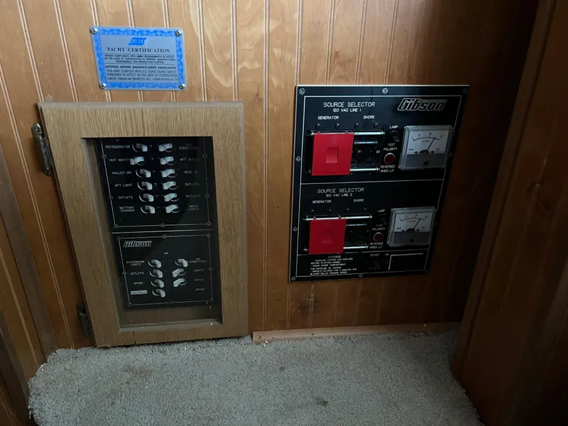 Slide: The Image of Control panel of a 1996 Gibson 41 Sunsport boat, featuring switches and gauges. - 8