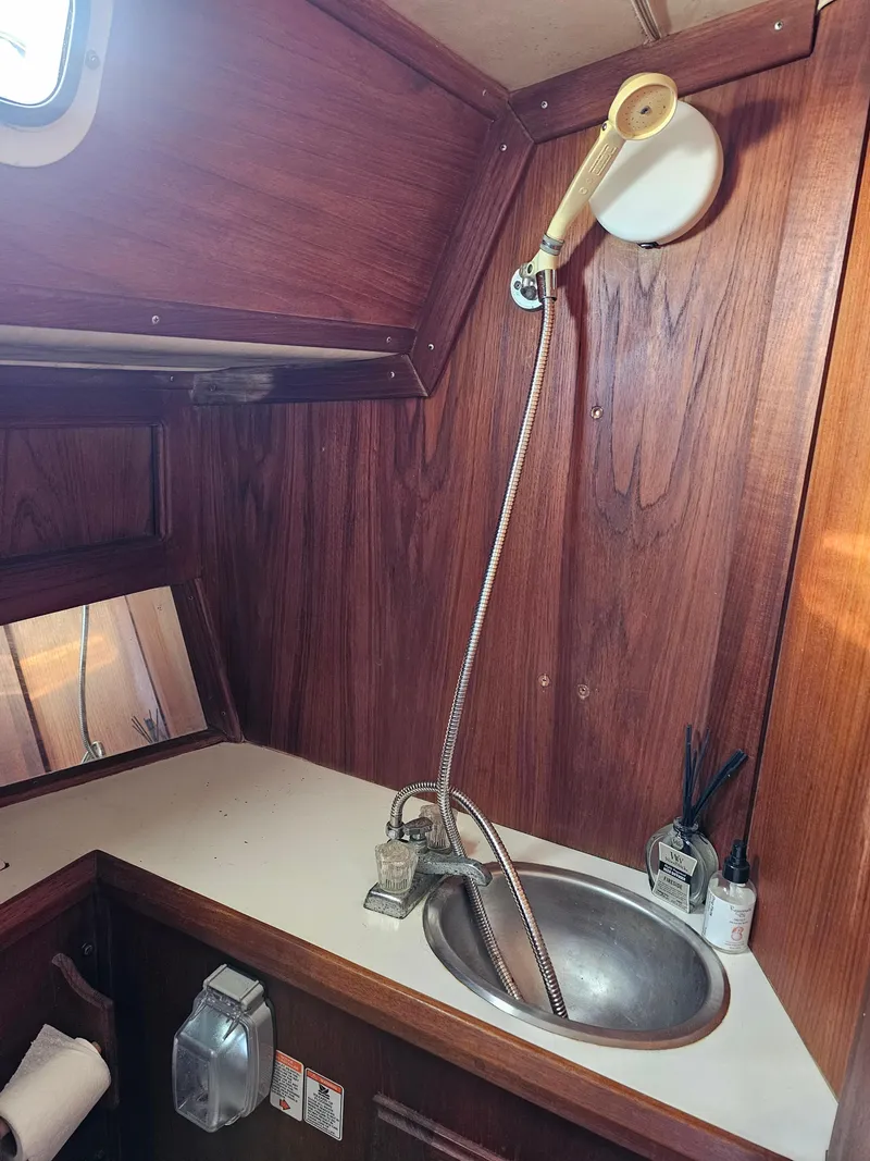 Slide: The Image of 1984 Schock NY 36 yacht bathroom with wooden interior and stainless steel sink. - 19
