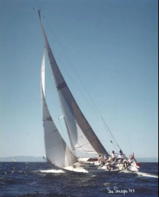 Slide: The Image of Sailing yacht Schock NY 36, 1984 model, gliding on open water under clear skies. - 2