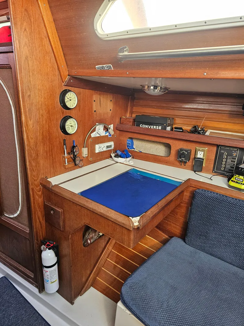 Slide: The Image of Interior of a 1984 Schock NY 36 sailboat with navigation station and wooden cabinetry. - 23