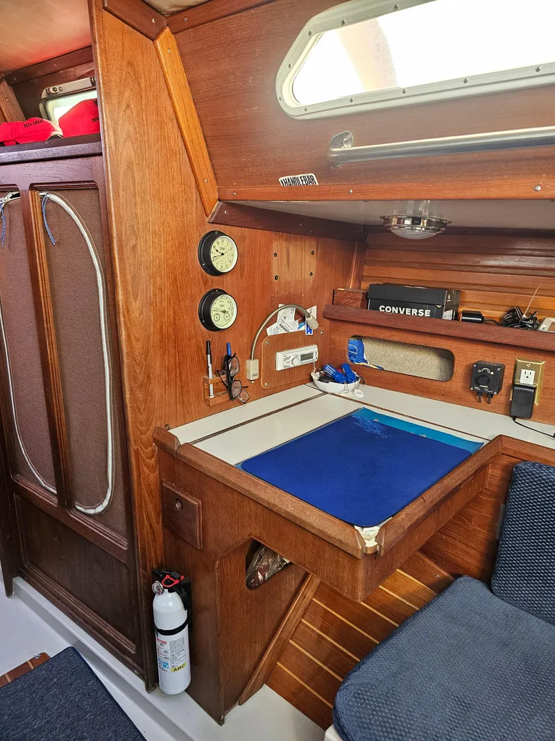 Slide: The Image of 1984 Schock NY 36 sailboat interior with navigation station and wooden cabinetry. - 24