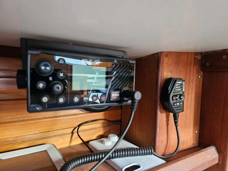 Slide: The Image of Control panel and radio equipment inside a 1984 Schock NY 36 sailboat cabin. - 26