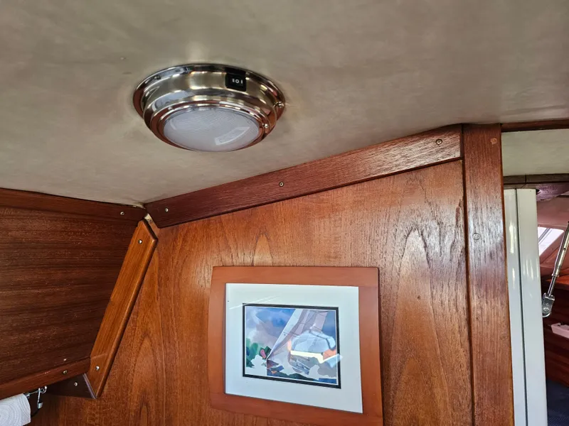 Slide: The Image of Interior of 1984 Schock NY 36 yacht with wood paneling and framed artwork. - 29