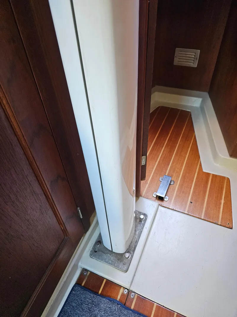 Slide: The Image of Interior view of 1984 Schock NY 36 sailboat, featuring wooden flooring and structural details. - 31