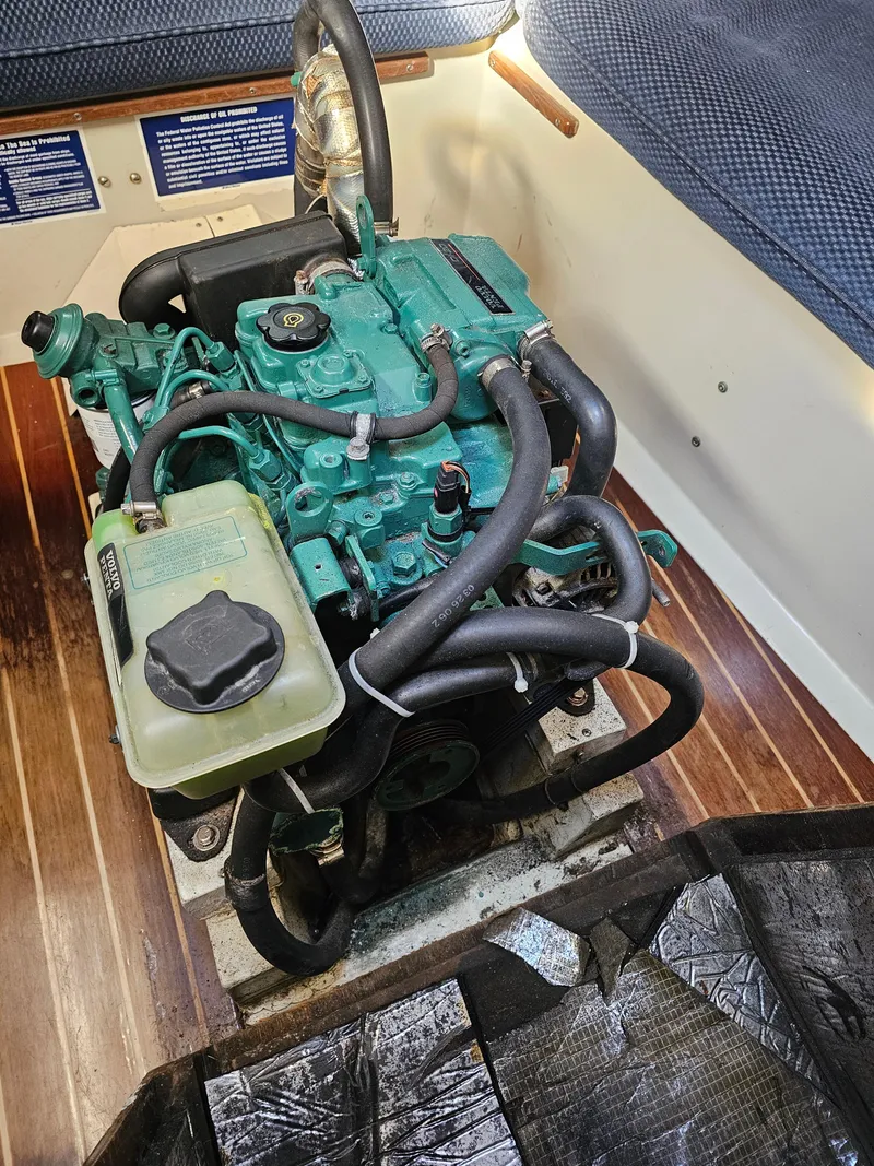 Slide: The Image of Engine of a 1984 Schock NY 36 sailboat, featuring a compact design and green components. - 33