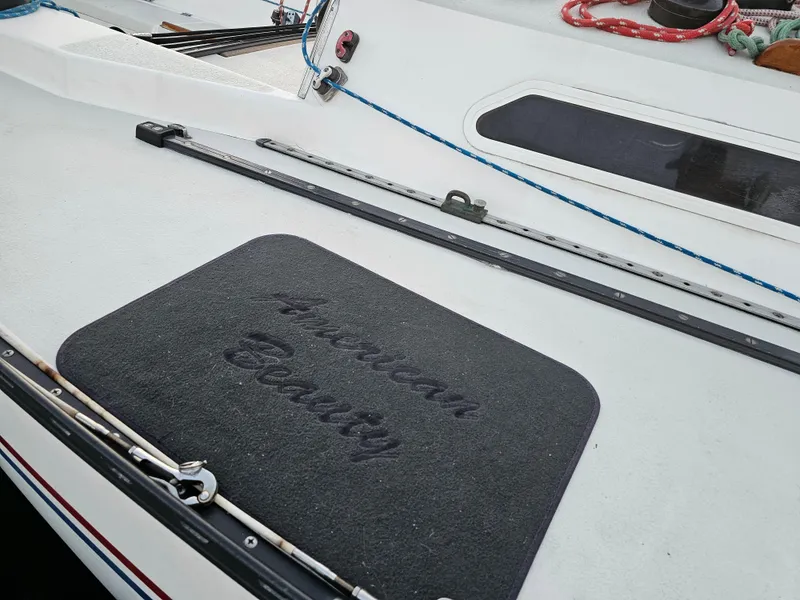 Slide: The Image of Deck of 1984 Schock NY 36 sailboat with "American Beauty" mat. - 6